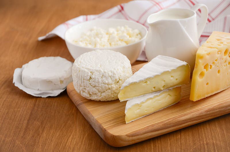 Verse zuivelproducten Melk, kaas, Brie, camembert en kwark op de houten achtergrond royalty-vrije stock afbeelding Verse zuivelproducten Melk, kaas, Brie, camembert en kwark op de houten achtergrond royalty-vrije stock afbeelding
