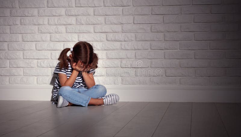 Verstoor droevig droevig kindmeisje in spanningsschreeuwen bij een lege donkere muur Verstoor droevig droevig kindmeisje in spanningsschreeuwen bij een lege donkere muur