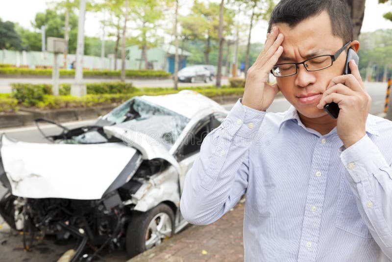 Verstoorde bestuurder die op mobiele telefoon met neerstortingsauto spreken stock afbeeldingen Verstoorde bestuurder die op mobiele telefoon met neerstortingsauto spreken stock afbeeldingen