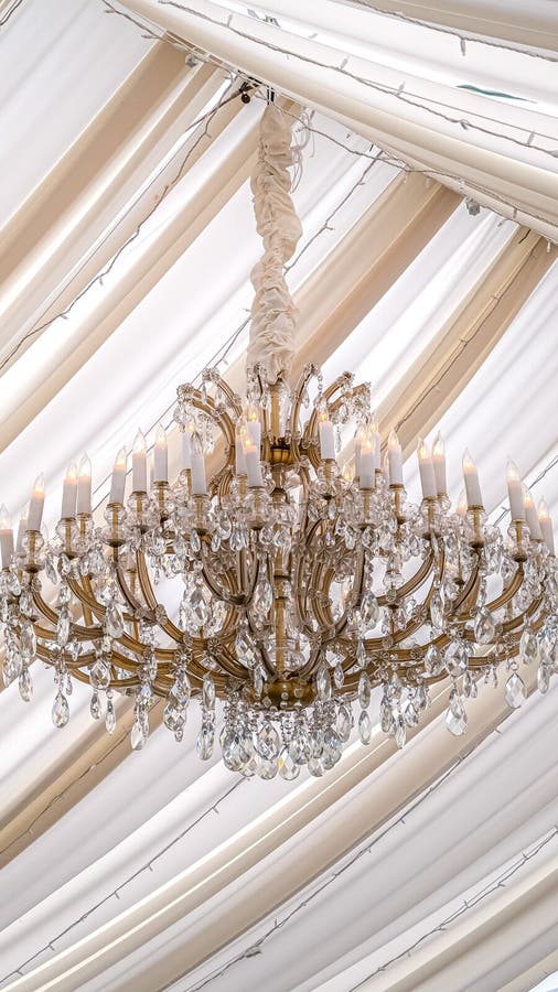 Vertical Beautiful chandelier with crystals and faux candles at a wedding venue