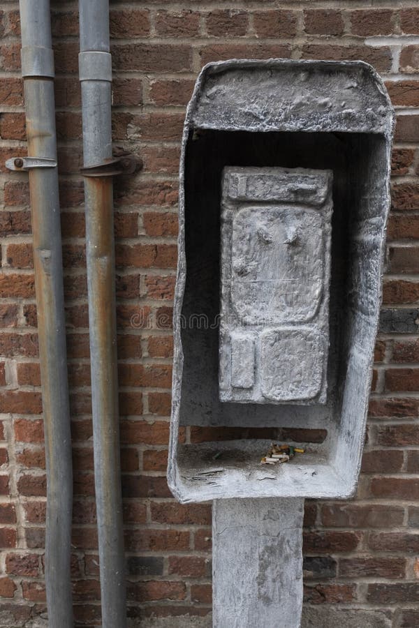 Vertical Closeup Shot of an Electrical Wires Box on a Brick Wall Stock