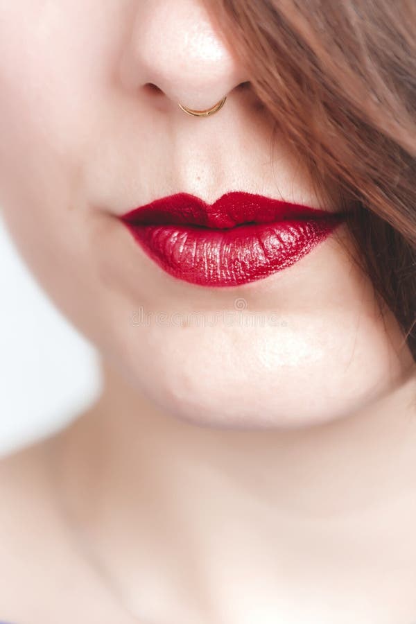 Vertical Closeup Shot of a Female Wearing Red Lipstick with a Slight ...