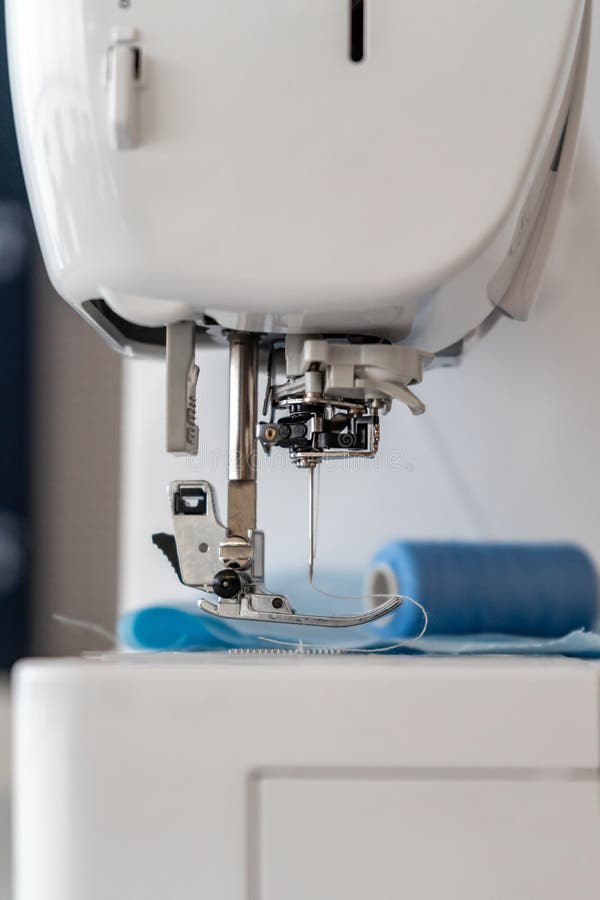 Vertical Closeup Shot of the Thread and the Needle of a Sewing Machine