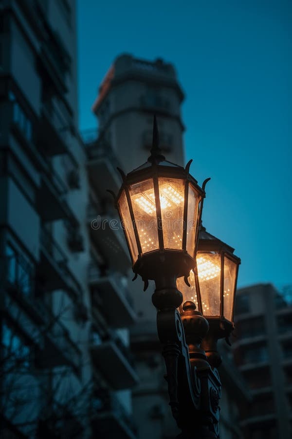 Vertical Closeup Shot of the Two Burning Street Lamps in the City at ...