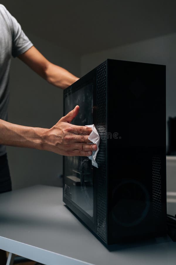 Vertical cropped shot of technician cleaning dust from computer case in workshop, emphasizing importance of maintenance royalty free stock photo