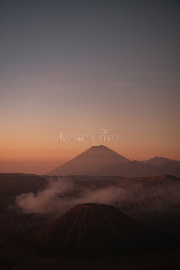 Vertical Elegance Bromo S Sunrise in Warm Cloud Embrace Stock Photo
