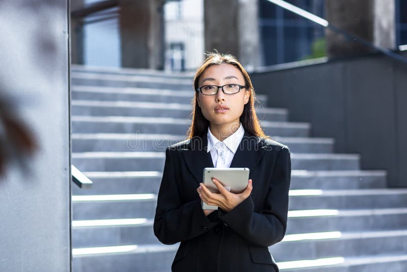 Vertical Frame Portrait Of Asian Female Teacher With Glasses Looking