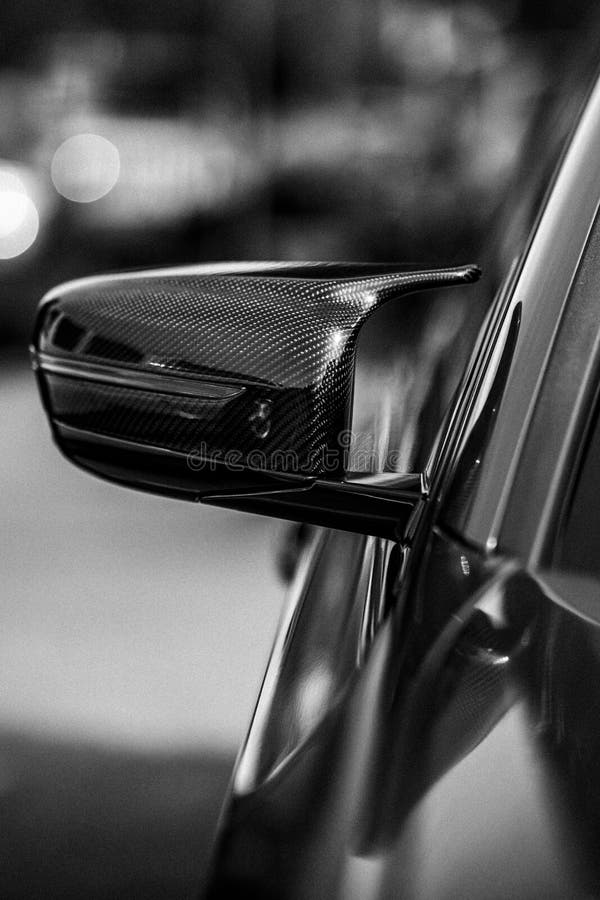 Vertical Grayscale Partial View of a Car Sideview Mirror Stock Image