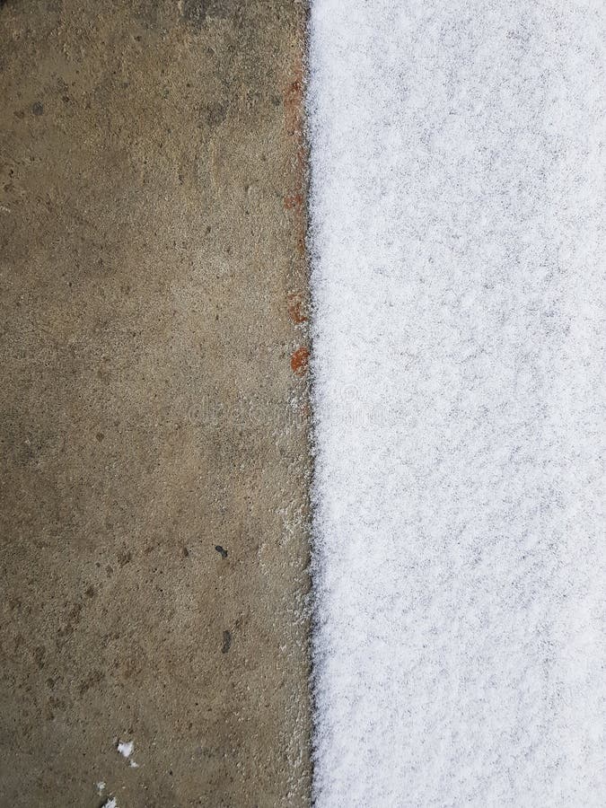 Vertical High Angle Shot of a Concrete Ground Halfcovered with Snow