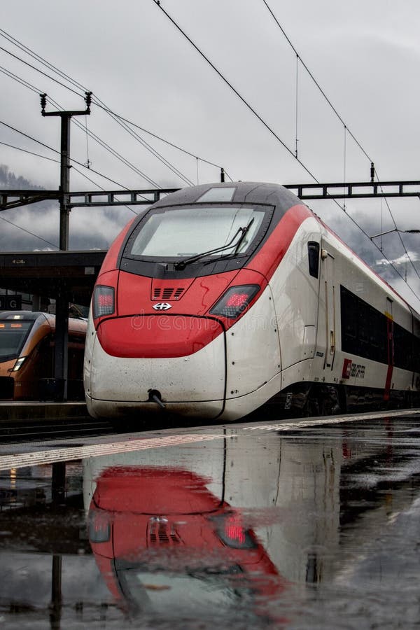 Vertical of a Passenger Train at the Station with Power Lines in the ...