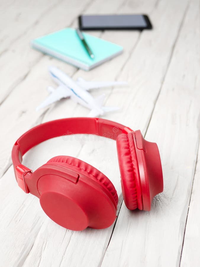 Vertical photo, Musical headphones with a notepad, with a smartphone with a white display for a playlist. Headphones on the table royalty free stock photo