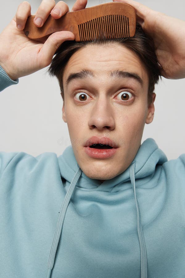 Vertical Portrait Photo .a Cute Slender Young Man Combs His Hair in a ...