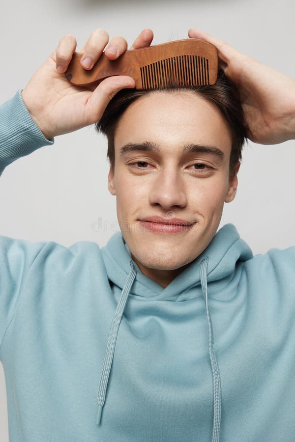 Vertical Portrait Photo .a Cute Slender Young Man Combs His Hair in a ...