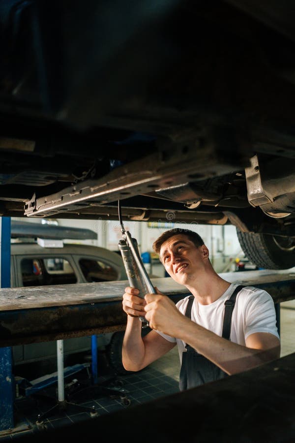 Vertical Portrait Of Serious Handsome Professional Male Car Mechanic In