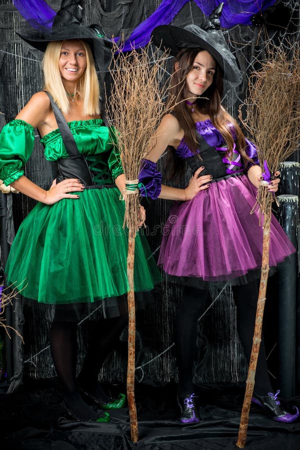 Vertical portrait of two enchanting witch with brooms stock photography Vertical portrait of two enchanting witch with brooms stock photography