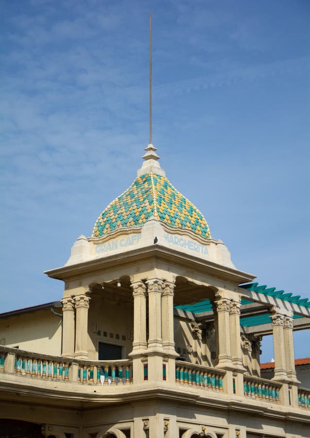 Vertical shot of a balcony with an ancient architectural design beneath a blue sky. stock image