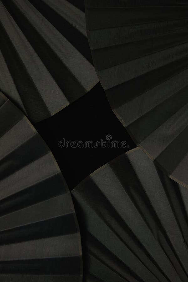 Vertical shot of the beautiful handheld fans on the black background stock photography