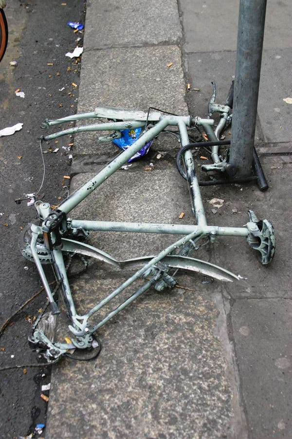 Vertical Shot of a Broken Bike without Wheels Tied To a Pole Stock