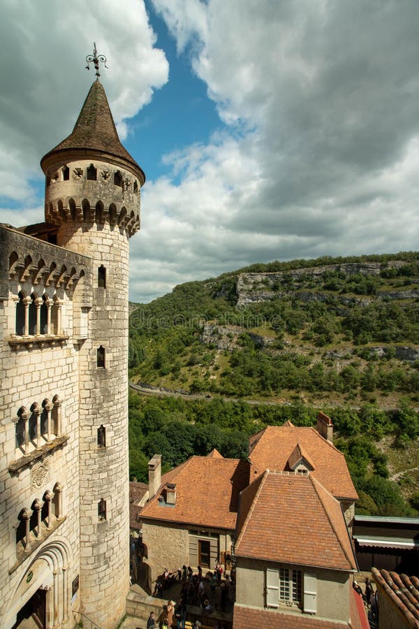 Vertical shot of a caste near a house with a hill in the background stock image