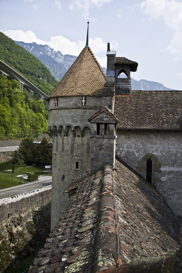 Vertical shot of the Chillon caste with mountains and a cloudy sky in the background stock photos