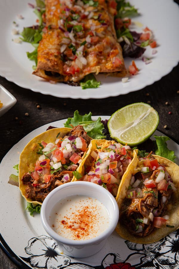 Vertical Shot of Delicious Tacos, White Sauce and Half a Lime on a