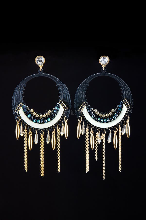 Vertical Shot of Elegant Earrings on the Black Background Stock Image