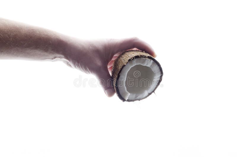 Concept of pouring coconut milk from fresh tasty coconut in male hand against whiet background stock image Concept of pouring coconut milk from fresh tasty coconut in male hand against whiet background stock image