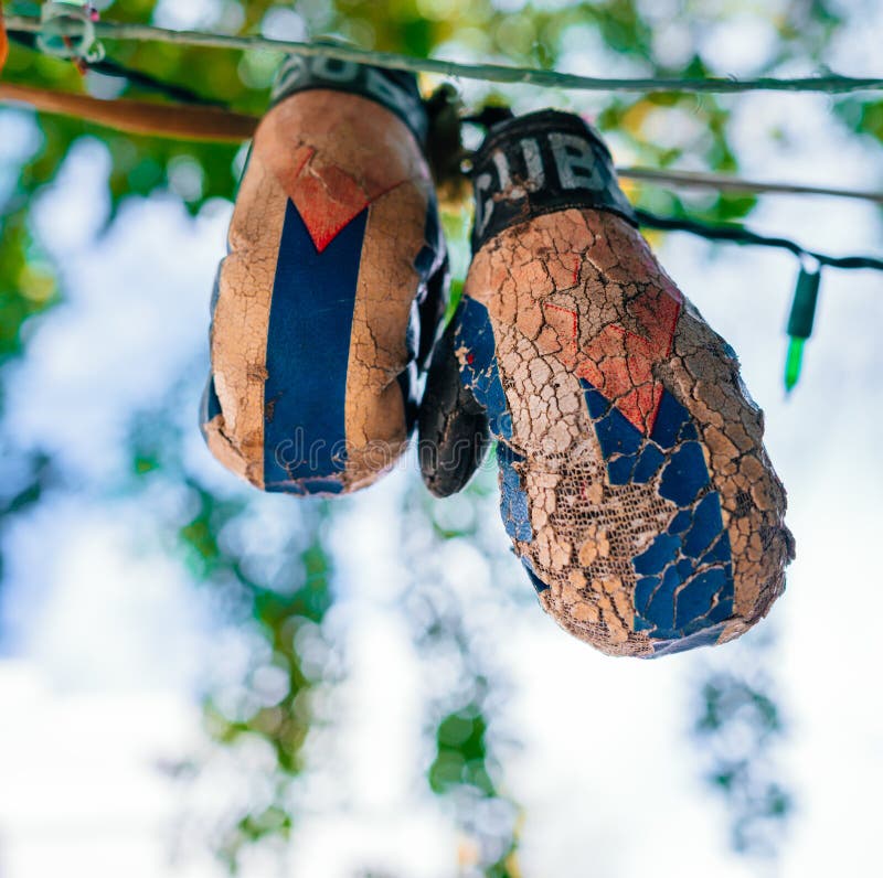 Vertical Shot of Old Boxing Gloves Hanging from the Wire Stock Image