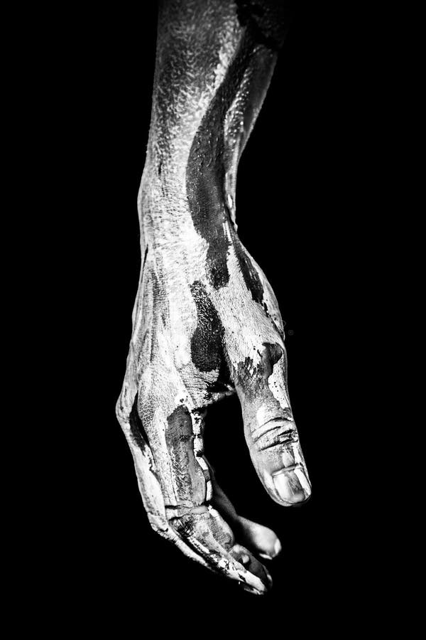Vertical shot of a painted human hand isolated on a black background stock images