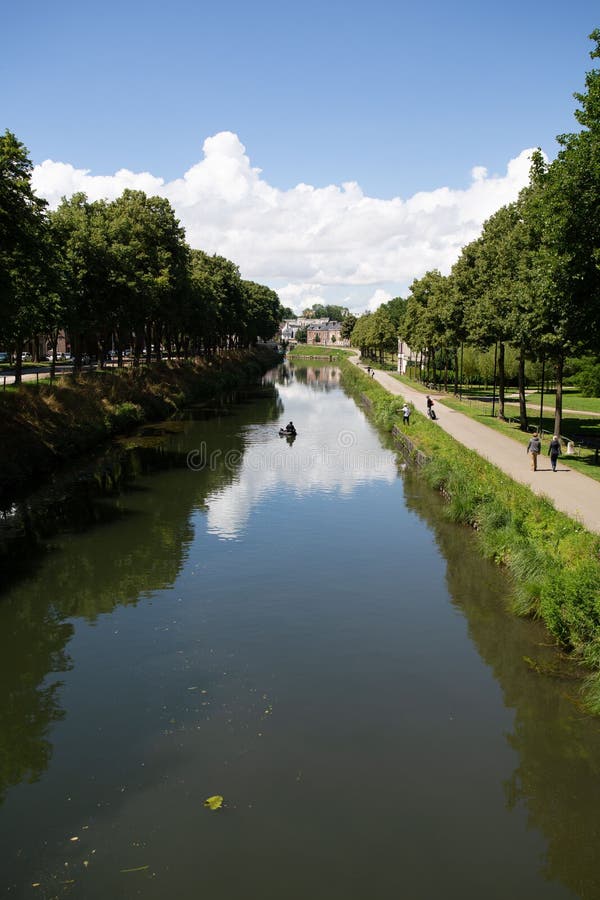 Vertical Shot of a River Flowing through a Park in Amiens France Vertical Shot of a River Flowing through a Park in Amiens France