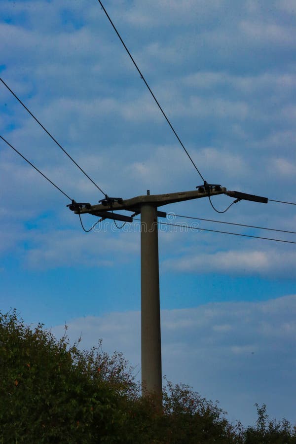 Vertical Shot of the Rural Electrical Post by the Road Stock Photo