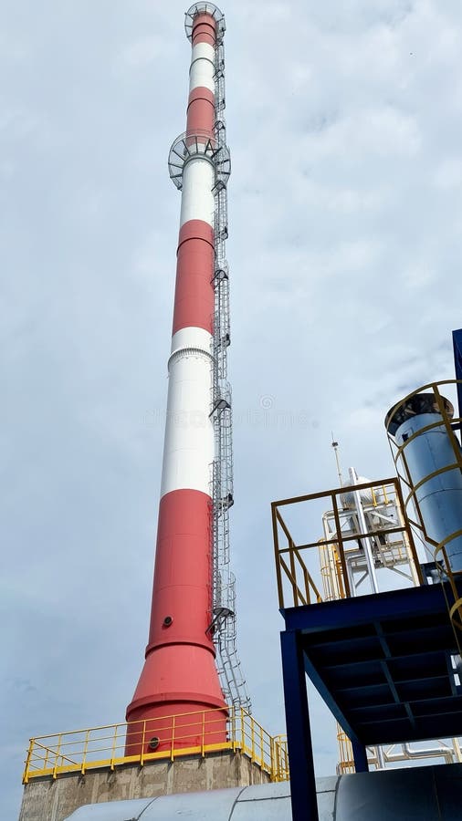 The vertical shot of the smoke stack of factory plants. stock photos