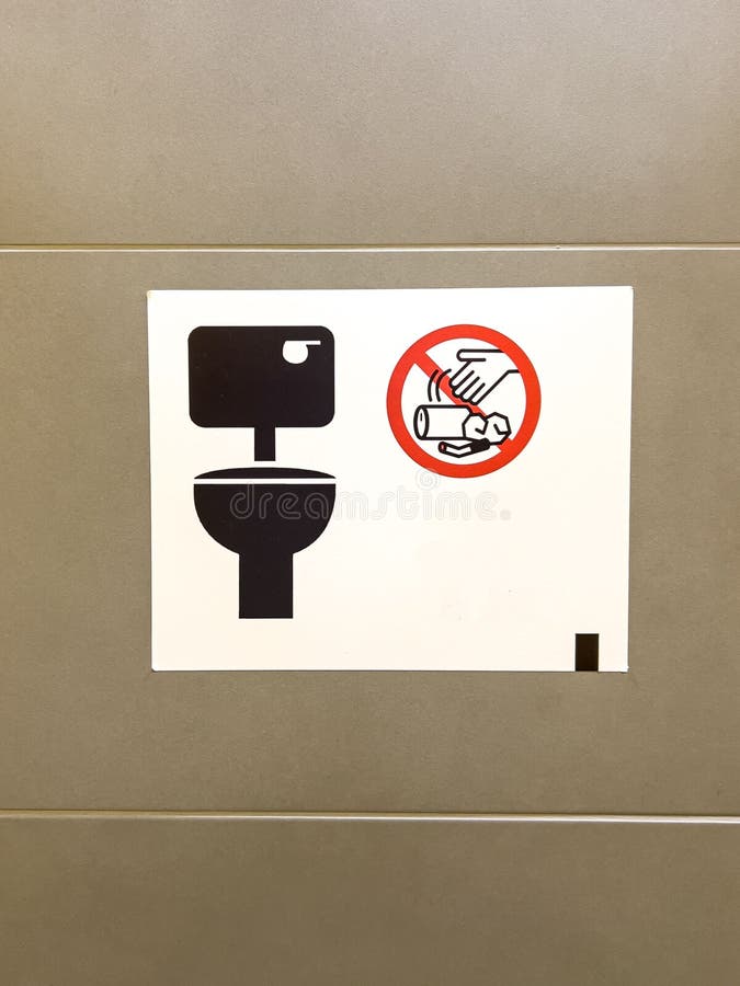Vertical shot of the toilet sign with garbage prohibited symbol on the wall stock images