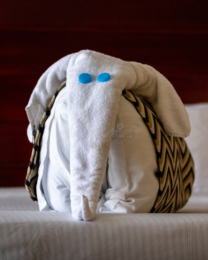 Vertical Shot of a Towel Elephant Decorating the Hotel Bed on the