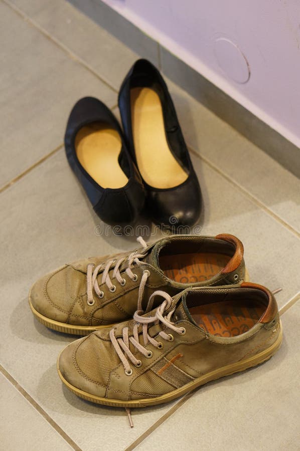 Vertical Shot of Two Pairs of Shoes in the Hall Stock Image - Image of ...