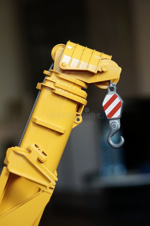 Vertical Shot of a Yellow Plastic Toy Crane with Hook Stock Image