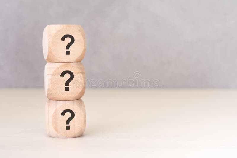 Vertical stack of wooden cubes with question mark symbols, FAQ concept. Conceptual pair with exclamation mark available in royalty free stock images
