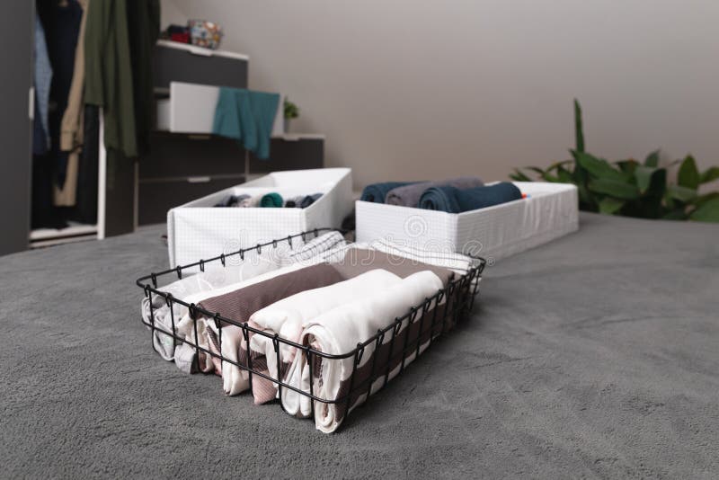 Vertical Storage of Clothing. Sorted Clothes in Baskets and Shelves in a Modern Bedromm Stock