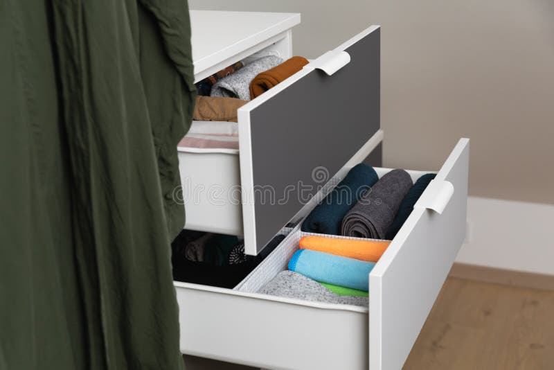 Vertical Storage of Clothing. Sorted Clothes in Baskets and Shelves in a Modern Bedromm Stock