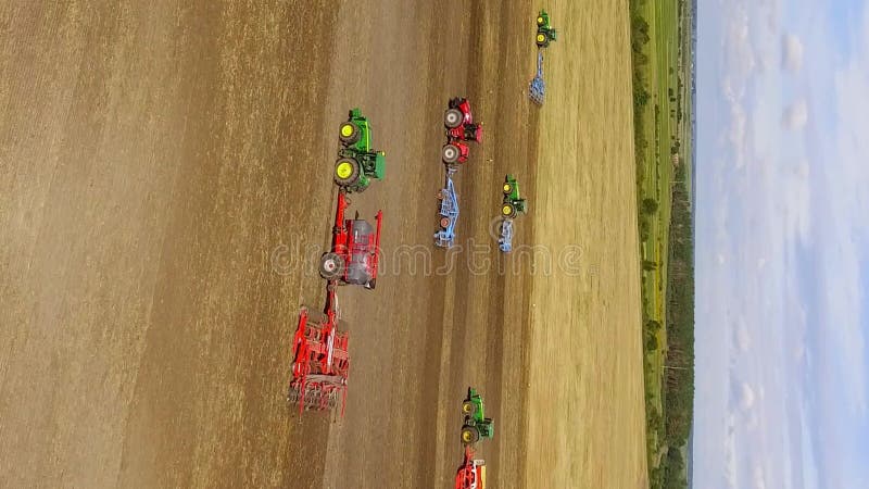 Vertical video. Sowing field and all kinds of tractor work stock footage