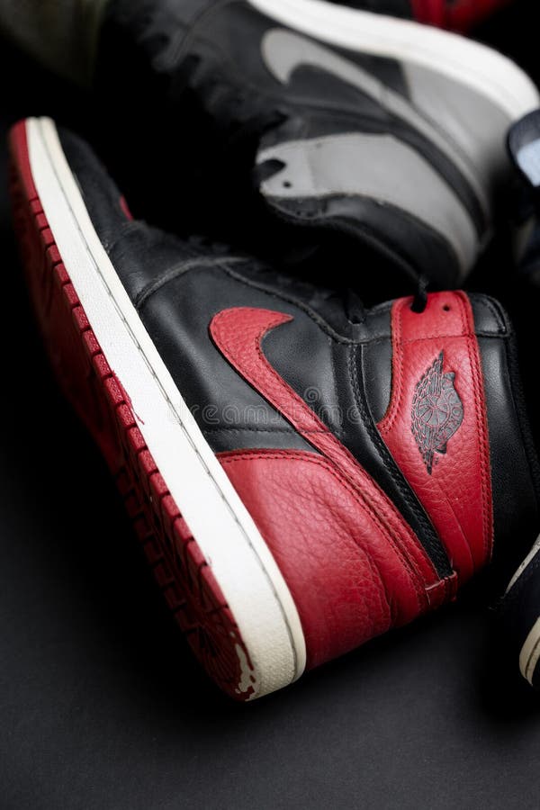 Vertical View of Red and Gray Nike Banned Air Jordan 1 Over the Black