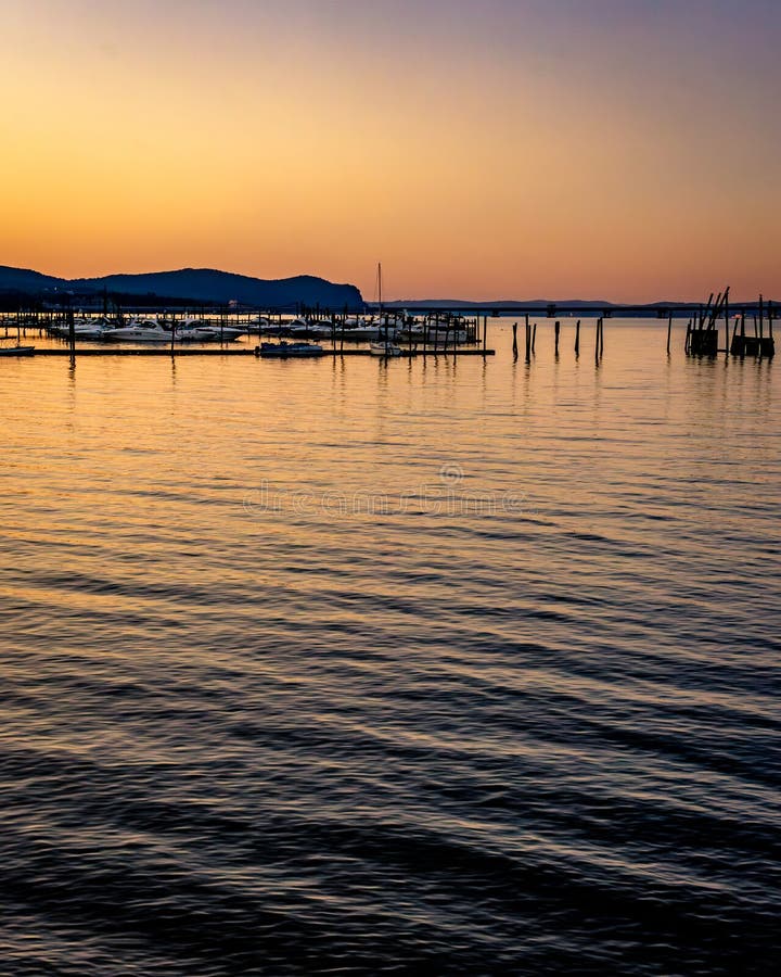 Vertical view of a sunset over the Hudson River and Piermontâ€™s marinas with reflections