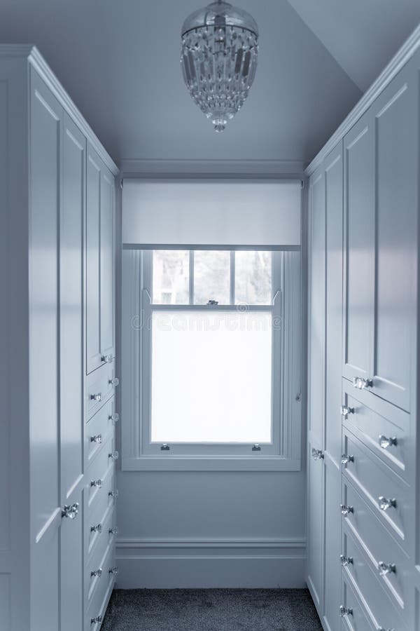 Vertical View of a Window in a Dressing Room with Drawers and Wardrobes