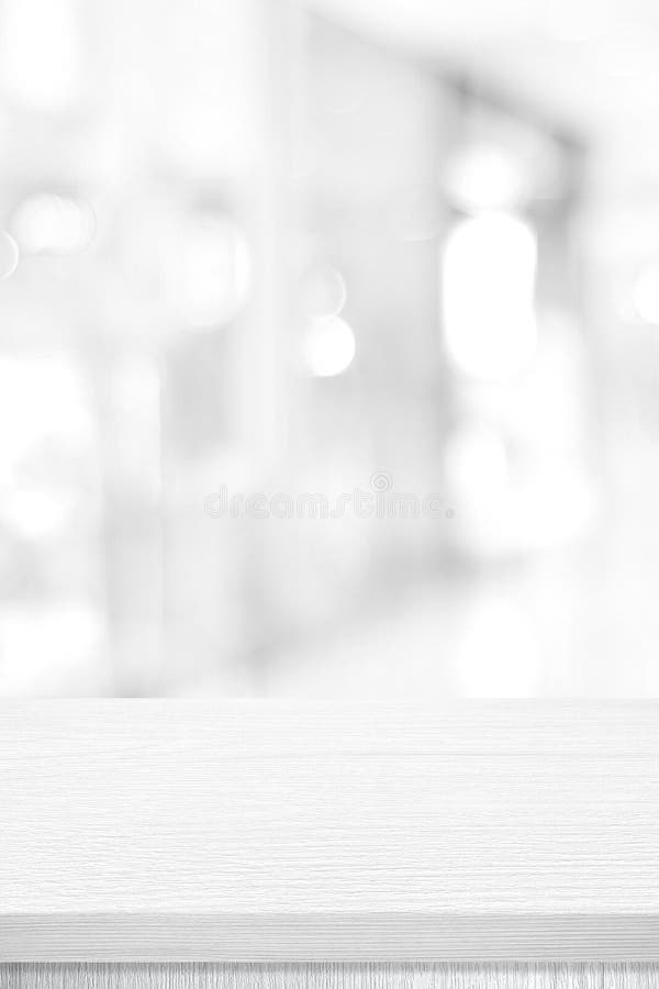 Vertical white table presentation, desk and blur background, Empty wood counter, shelf surface over blur restaurant white bokeh royalty free stock image