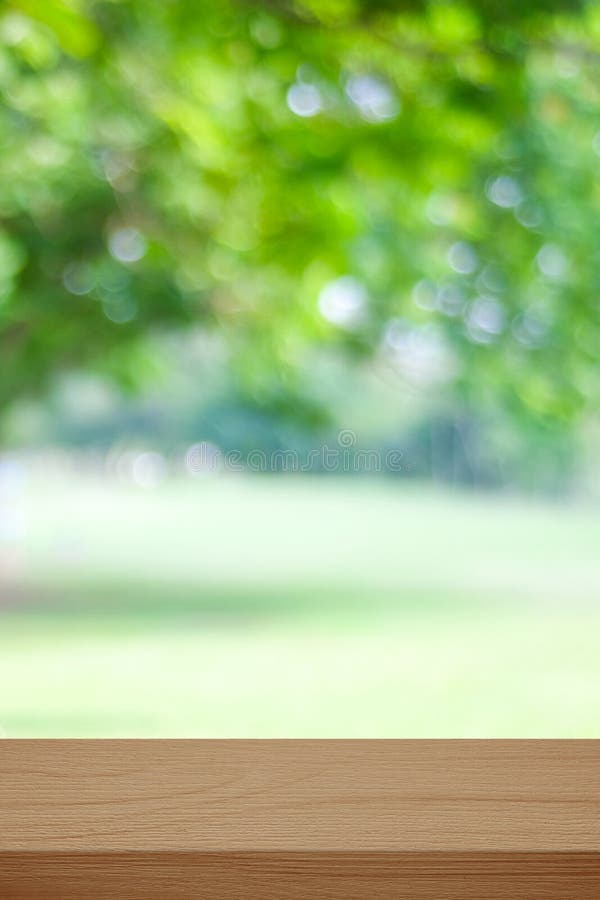 Vertical wooden table for food, product display over blur green garden background, Empty wood shelf, desk and blur tree park with royalty free stock photos