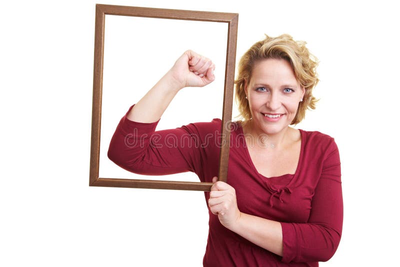 Woman holding an empty frame in front of her arm muscles. Woman holding an empty frame in front of her arm muscles