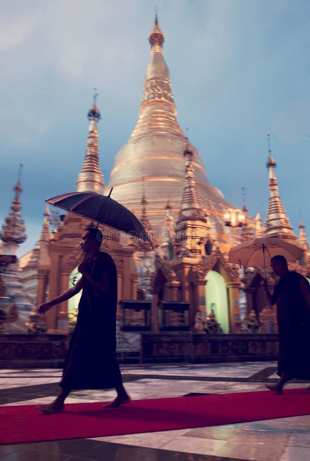 Verticalï¼Œ Monks walk round the Shwedagon pagoda