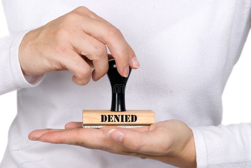 A woman holding a denied authorization stamp. A woman holding a denied authorization stamp