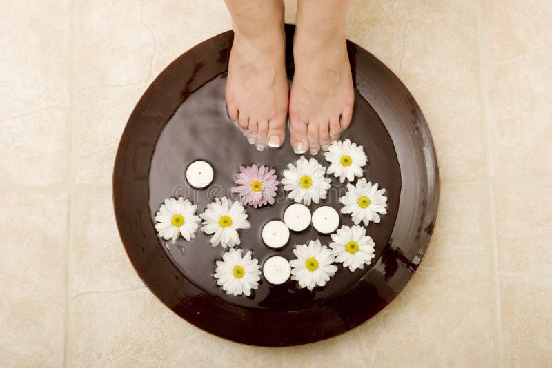 Woman's feet in bowl of water. Woman's feet in bowl of water