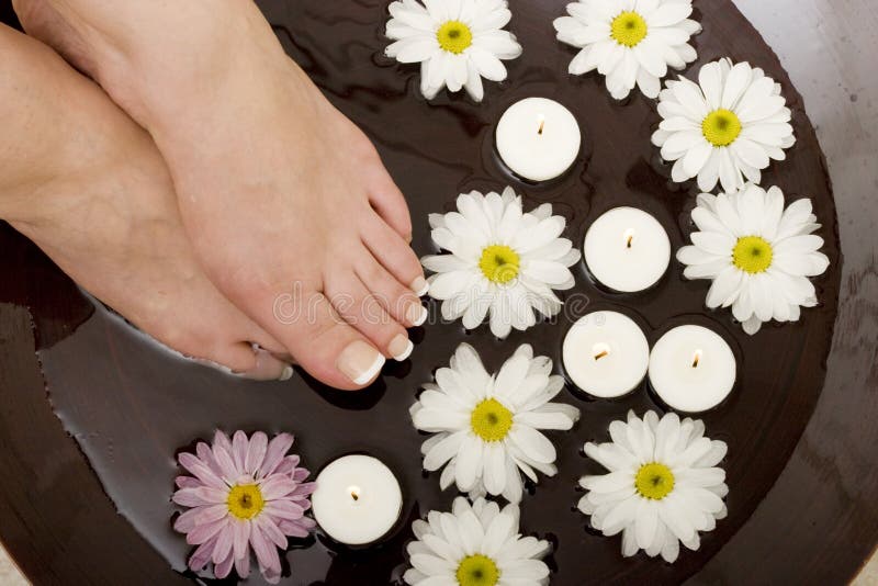 Woman's feet in bowl of water. Woman's feet in bowl of water